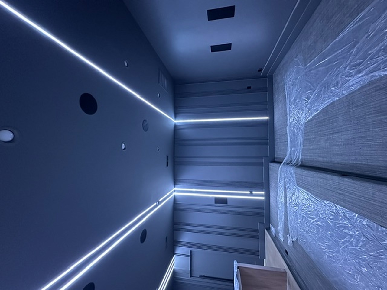 Custom linear LED ceiling lines in a media room